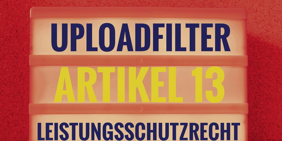 Illuminated panel with the german words Uploadfilter Artikel 13 Leistungsschutzrecht in english Upload filter Article 13 ancillary copyright