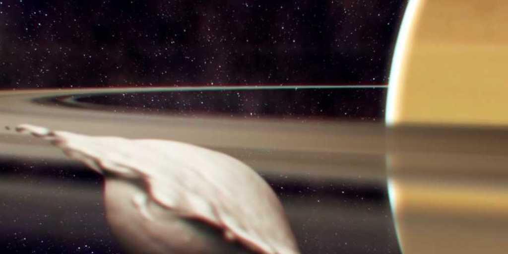 Entstehung von Atlas, einem der kleinen, inneren Monde des Saturns. Seine flache, ravioliartige Form kam bei der Kollision und Verschmelzung zweier gleich grosser Körper zustande. Die Illustration zeigt einen Moment, bevor die Neuausrichtung des Mondes aufgrund der Gezeiten abgeschlossen ist.