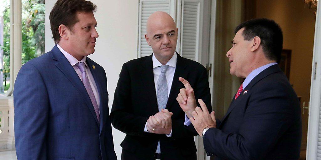 FIFA-Präsident Gianni Infantino diskutiert mit Conmebol-Chef Alejandro Dominguez (links) und Paraguays Präsident Horacio Cartes (rechts) FIFA-Präsident Gianni Infantino diskutiert mit Conmebol-Chef Alejandro Dominguez (links) und Paraguays Präsident Horacio Cartes (rechts)