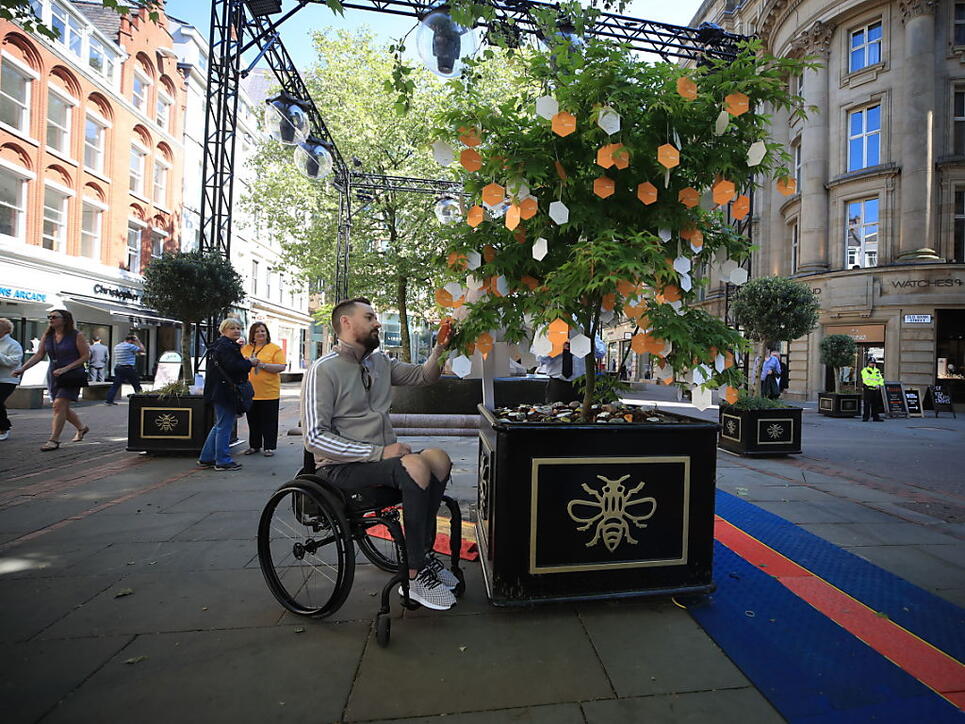 Ein Opfer des Terroranschlags von Manchester liest Nachrichten, die an einem "Baum der Hoffnung" auf dem St Ann's Square in Manchester hinterlassen wurden.
