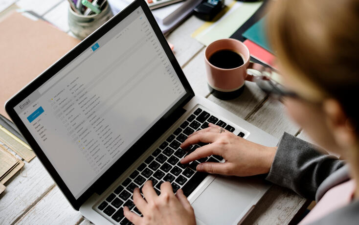 Businesswoman Checking E-mail Online on Laptop