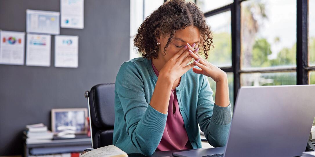 Stressed multiethnic businesswoman at work