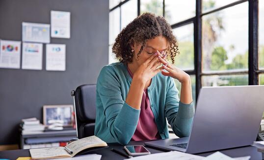 Stressed multiethnic businesswoman at work