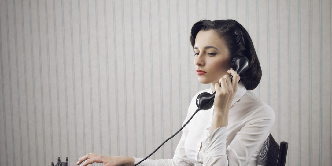 Woman talking on phone at desk Woman talking on phone at desk