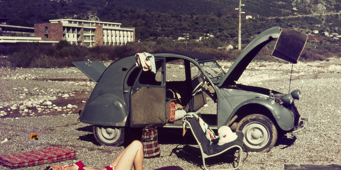 Young woman relaxing with her car.