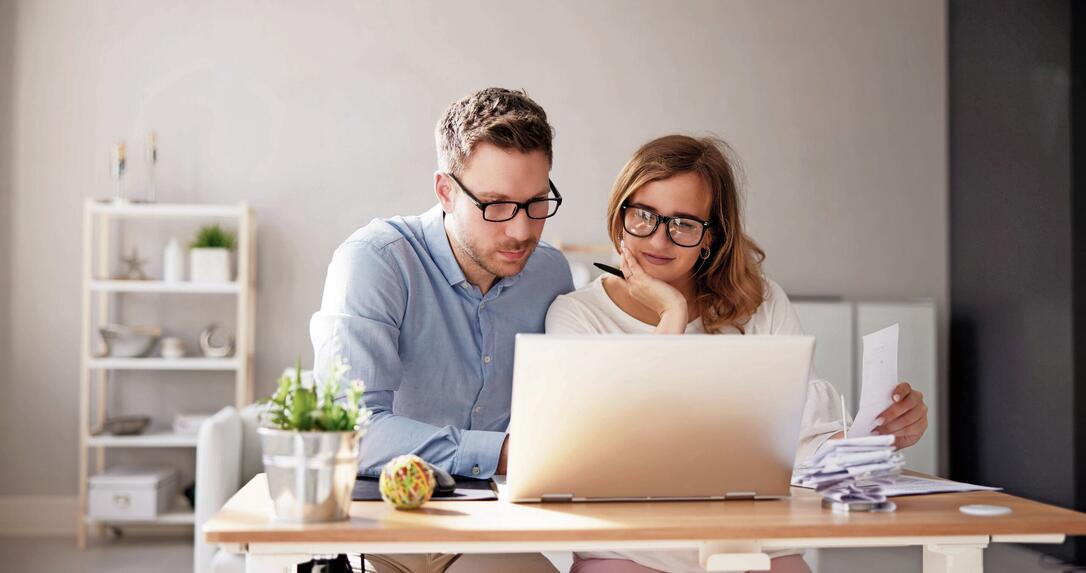 Happy Family Using Calculator For Tax