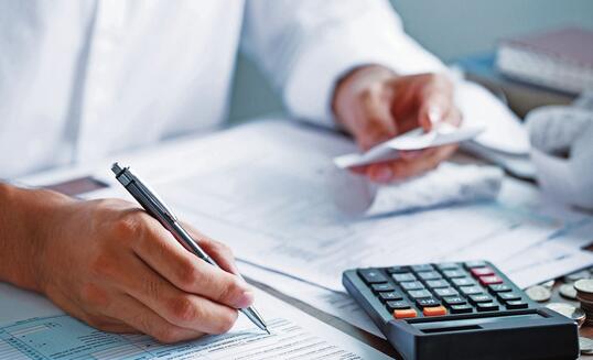 Man hand filling US tax form. tax form us business income office Financial document. Tax time.Tax concept. Close-up.