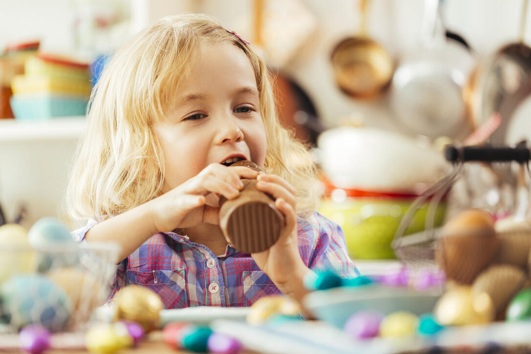 Little Girl Eating Chocolate Easter Bunny