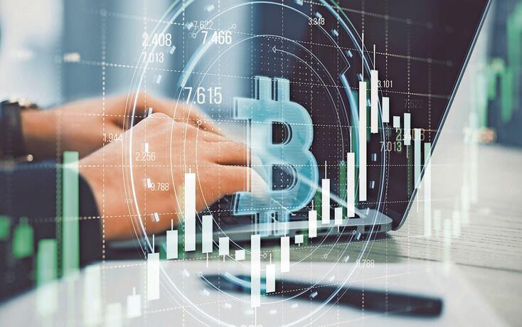 Close up of male hands using laptop with creative round bitcoin hologram on blurry grid background with forex chart. Online banking, cryptocurrency and finance concept. Double exposure.