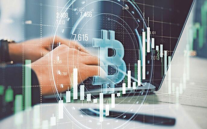 Close up of male hands using laptop with creative round bitcoin hologram on blurry grid background with forex chart. Online banking, cryptocurrency and finance concept. Double exposure.