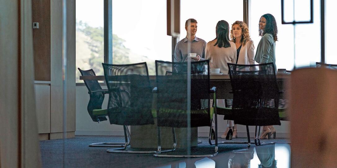 Business people in meeting seen through glass Business people in meeting seen through glass