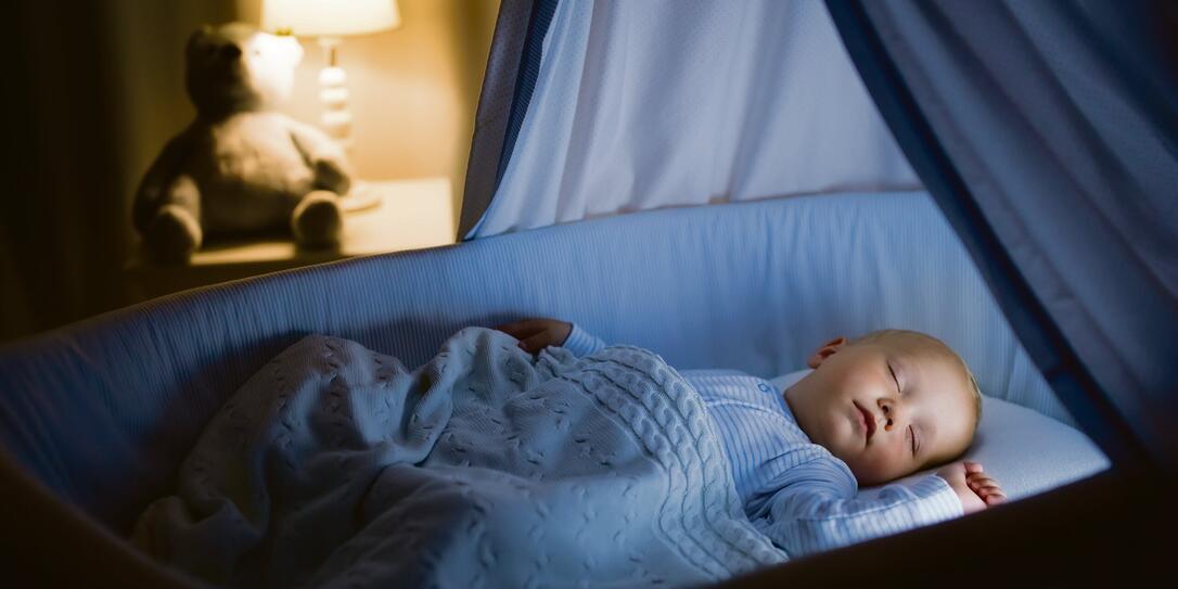 Baby boy drinking milk in bed